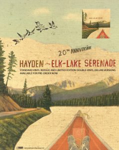 Elk-Lake Serenade 20th anniversary poster featuring the tip of a canoe in water with the text "Hayden ~ Elk-Lake Serenade 20th Anniversary" and release details indicating a standard and deluxe version available for pre-order.